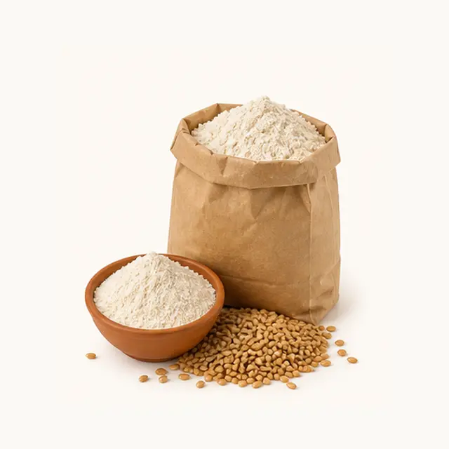 Paper bag of whole wheat atta flour with grains and a small bowl