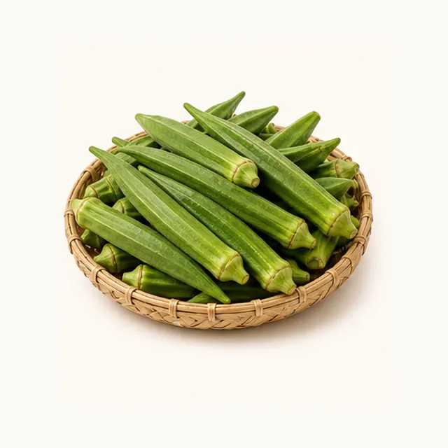 Fresh green okra pods arranged in a shallow woven basket