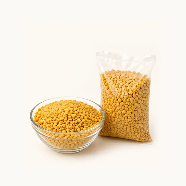 Yellow toor dal lentils in a glass bowl and clear pouch