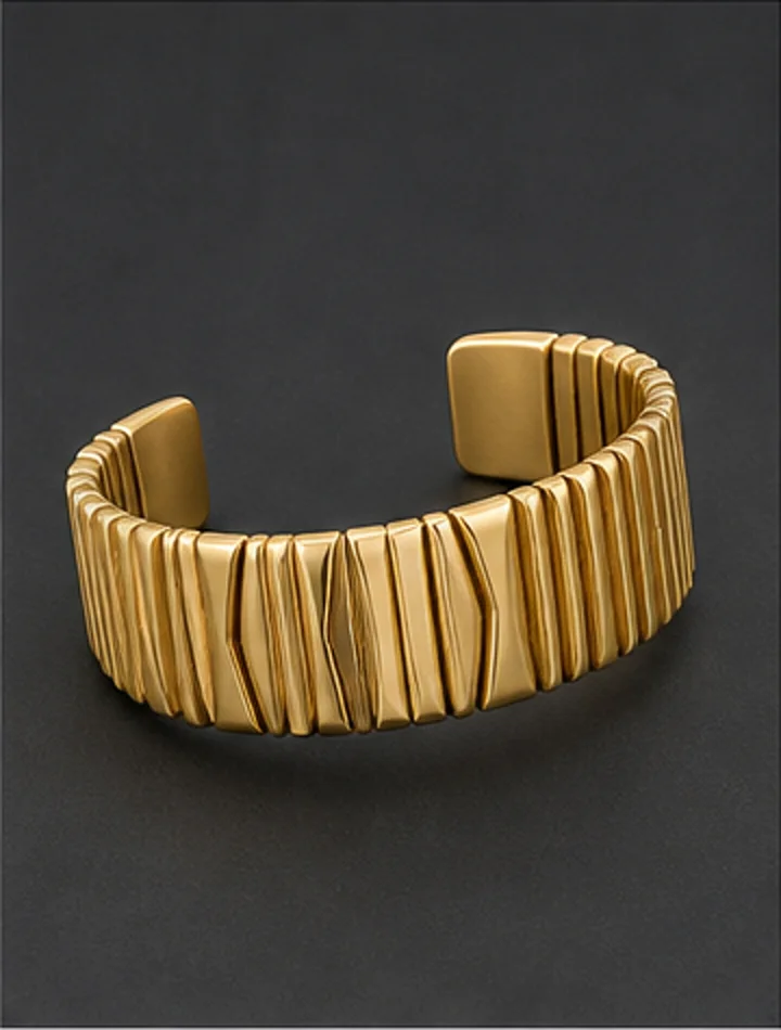 Wide articulated gold cuff with geometric ridges
