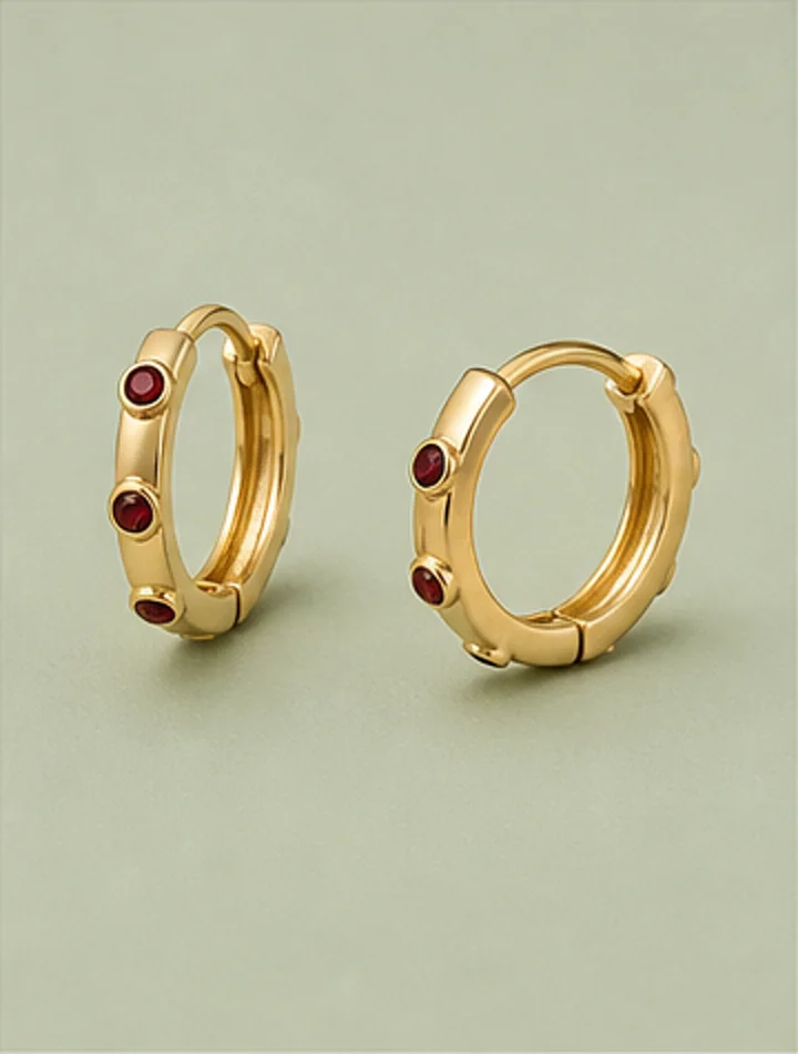 Small gold hoop earrings with garnet accents
